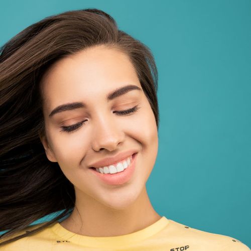 Person smiling and looking serene after a light workout session.